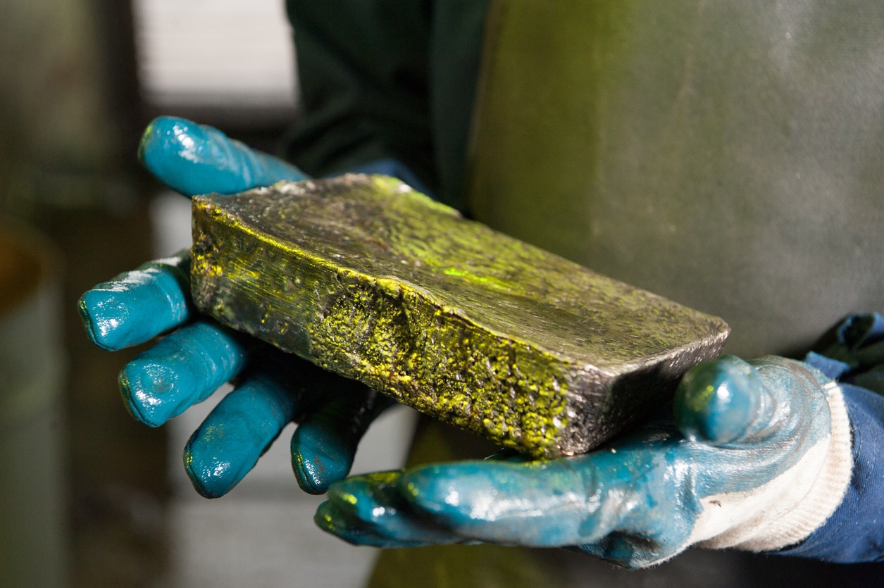Raw gold ingot in the hands